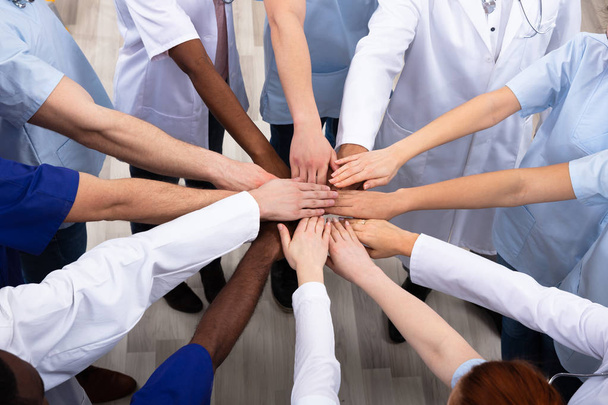 Directly Above Shot Of Medical Team Stacking Hands Together At Hospital - Foto, immagini