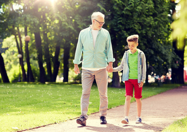 grandfather and grandson walking at summer park - 写真・画像