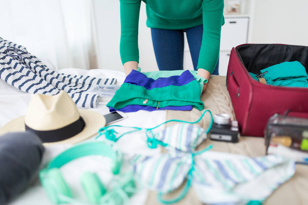 woman packing travel bag at home or hotel room - Foto, Imagem