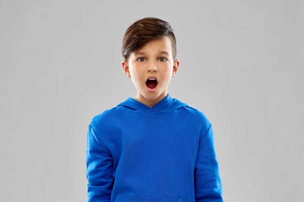 shocked boy in blue hoodie - Photo, image