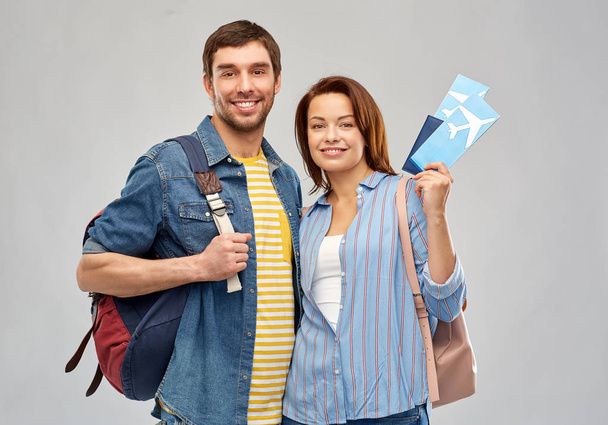 happy couple with air tickets, bags and passport - 写真・画像