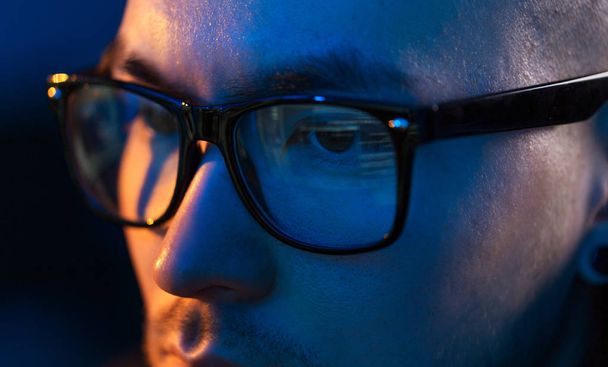 close up of hacker in glasses looking at screen - Foto, imagen