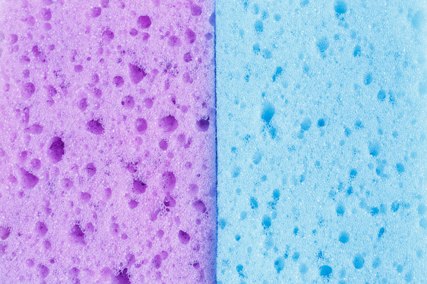 Кольорові губки для миття посуду та інших домашніх потреб. Вид зверху. Текстура двох фіолетових і синіх губок, поролону
 - Фото, зображення