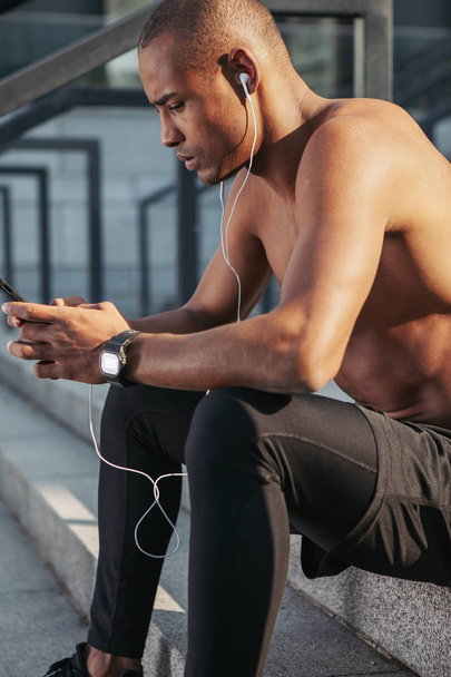Man checking a playlist before training. - Photo, image
