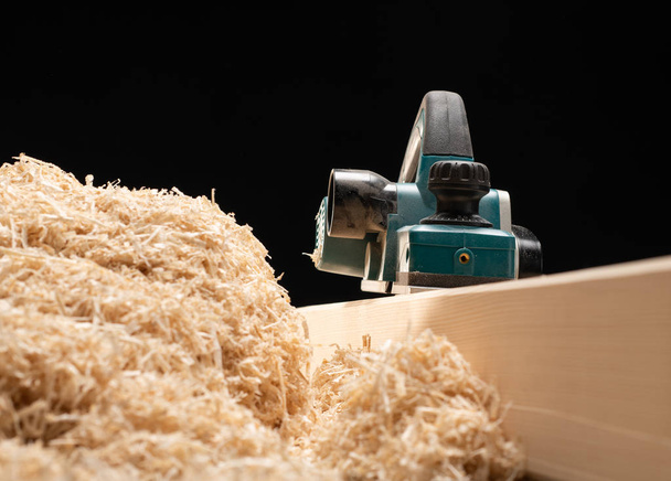 Isolated ectrical planer near bunch of sawdust  - Photo, Image