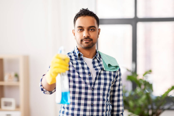smiling indian man with detergent cleaning at home - Fotografie, Obrázek