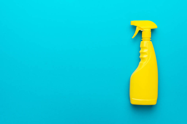 flat lay image of yellow plastic dispenser on blue background with copy space - Foto, imagen