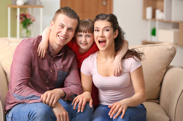 Happy couple with little adopted girl at home - Photo, Image