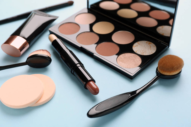 Set of cosmetics for contouring makeup on color background - Photo, Image