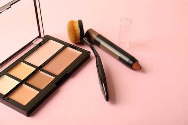 Set of cosmetics for contouring makeup on color background - Fotografie, Obrázek