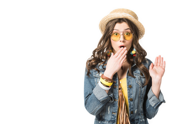 front view of shocked boho girl covering mouth with hand isolated on white - 写真・画像