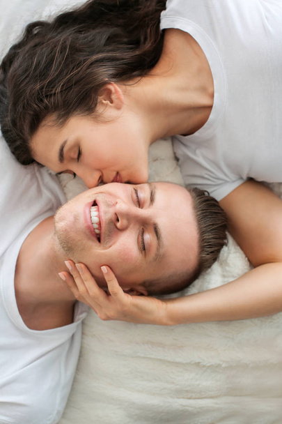 Adorable loving couple lying in bed - Фото, зображення