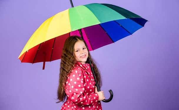 rain protection. Rainbow. happy little girl with colorful umbrella. autumn fashion. little girl in raincoat. cheerful hipster child in positive mood. Enjoy the silence - Fotoğraf, Görsel