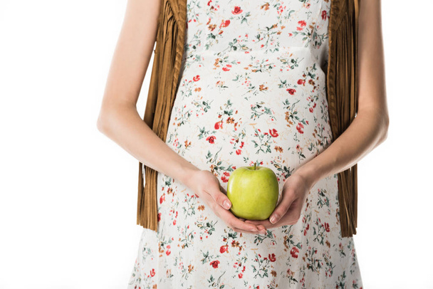 白で隔離された緑のリンゴを保持している妊娠中の女性のトリミングされたビュー - 写真・画像