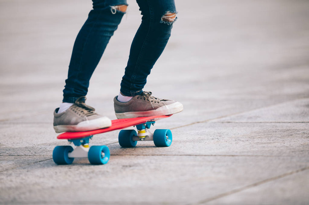 woman skateboarder legs skateboarding at city  - Фото, изображение