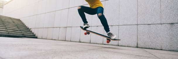 woman skateboarder legs skateboarding at city - Foto, Imagen