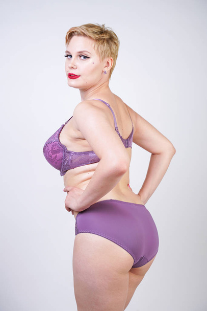 pretty curvy short hair girl posing in purple fashion lace lingerie in the white studio alone - 写真・画像