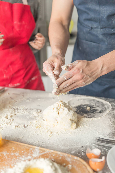 man and woman hands dough in the kitchen - Φωτογραφία, εικόνα