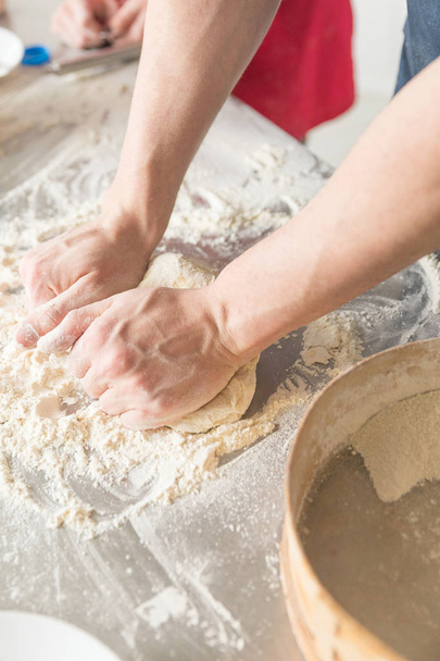 man and woman hands dough in the kitchen - Fotó, kép