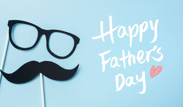 Top view of fathers day layout with silhouette of eyeglasses and beard, copy space for mockup. - Фото, зображення