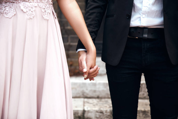 Portrait of young woman  and man holding hands - Foto, imagen