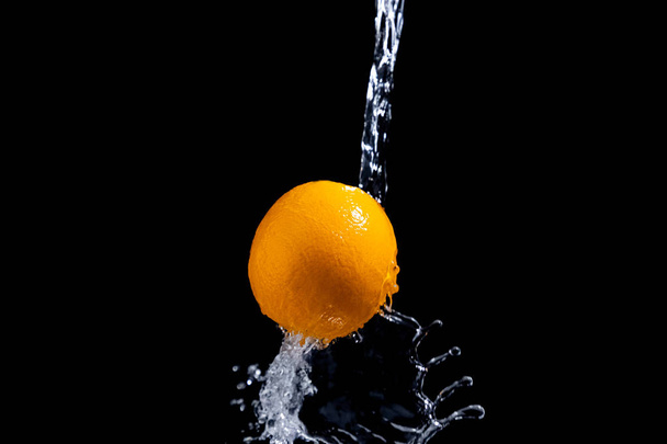 orange splash on black background - Fotografie, Obrázek