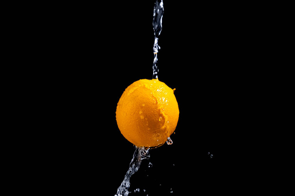 orange splash on black background - Foto, immagini