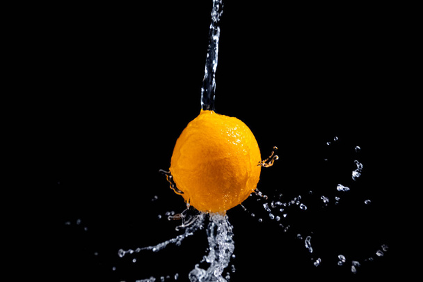 orange splash on black background - Foto, Imagen