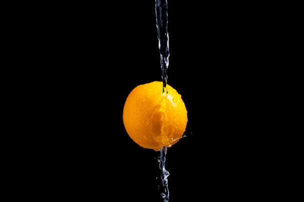 orange splash on black background - Photo, image