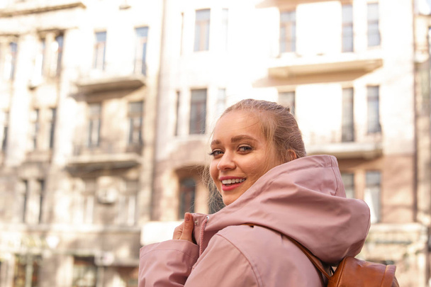 Portrait of happy young woman on city street - Zdjęcie, obraz