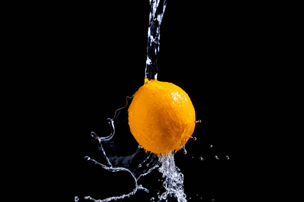 Siyah arkaplanda turuncu sıçrama - Fotoğraf, Görsel