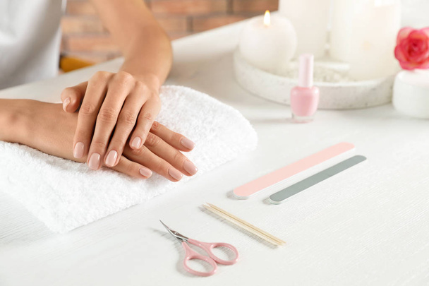 Woman waiting for manicure at table, closeup with space for text. Spa treatment - Photo, Image