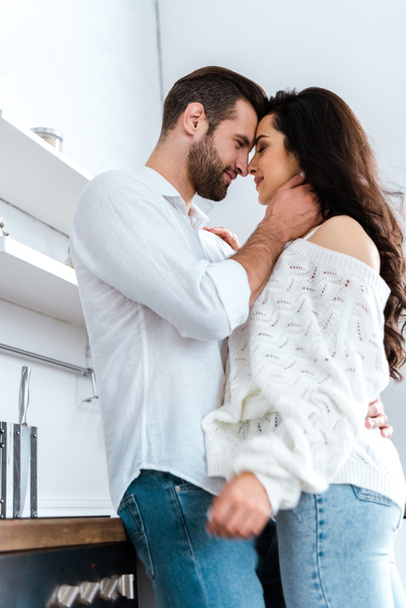 low angle view of lovely gently couple embracing at kitchen - Fotoğraf, Görsel