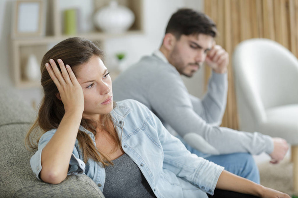 offended upset man and woman sitting separately on couch - Photo, image