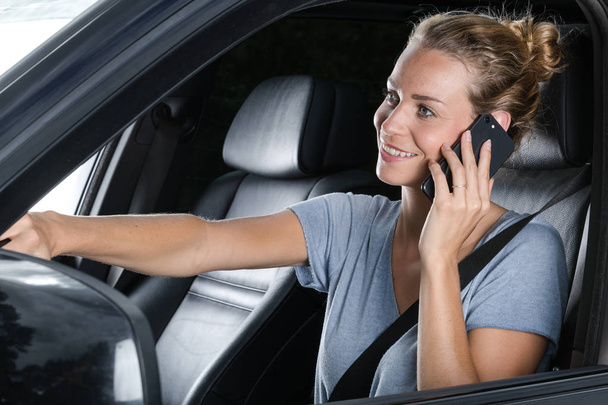 arabasını sürerken telefonda güzel genç kadın - Fotoğraf, Görsel