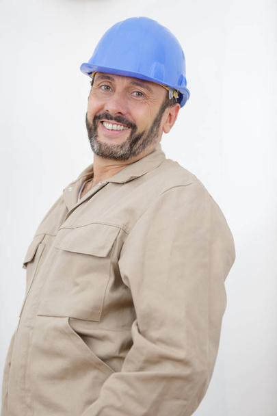 happy manual worker standing inside - Photo, Image