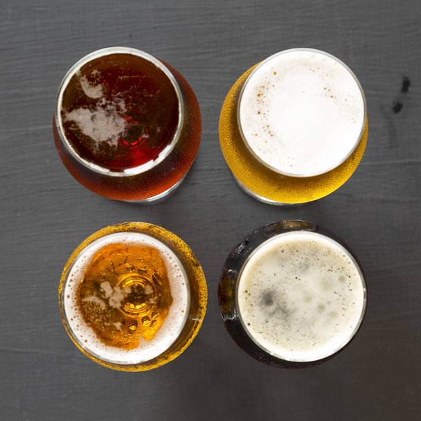 Assorted beers on a black background, top view. Overhead, from a - Fotó, kép