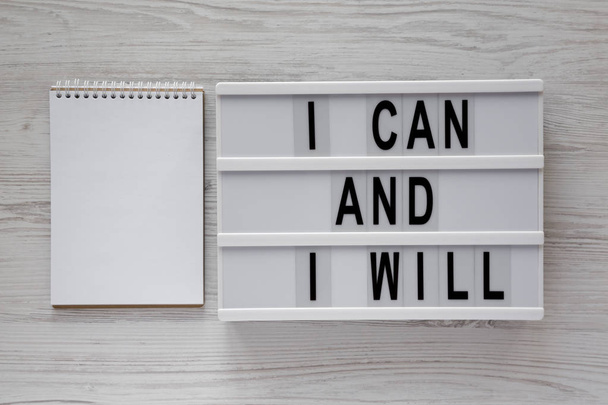 'I can and I will' words on a modern board, blank notepad over w - Foto, Imagen