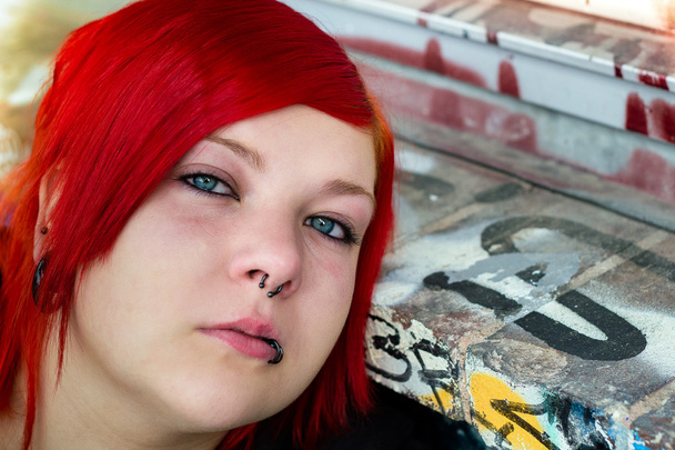 Redhead girl with piercing on graffiti background - Photo, Image