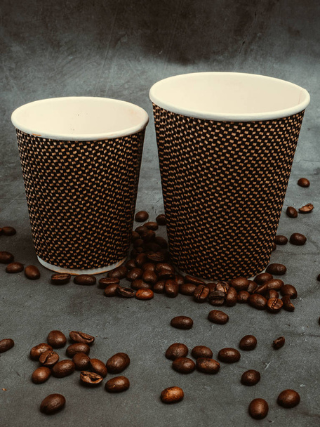 two beautiful disposable paper coffee cups with beans, with filter - Photo, Image