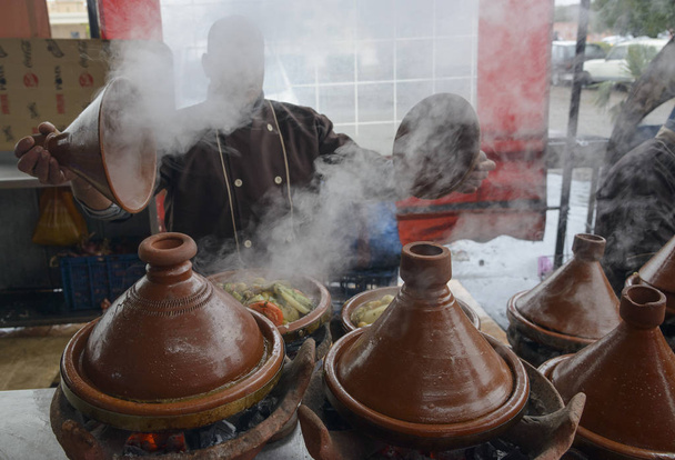 Cook demonstrates what kind of vegetarian tagine he cooked - Photo, Image