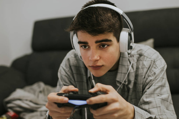young man with the joystick playing video games - Foto, Bild
