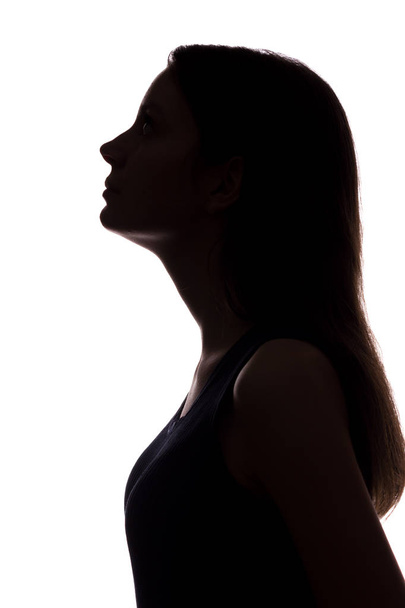 Young woman looking up - vertical silhouette - Zdjęcie, obraz