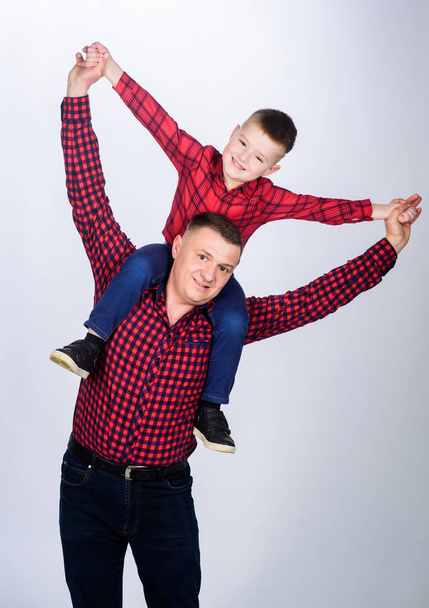 In the dreamland. happy family. little boy with dad man. fathers day. childhood. parenting. father and son in red checkered shirt. Cowboy couture. No cares and no rush. Using imagination - Photo, Image