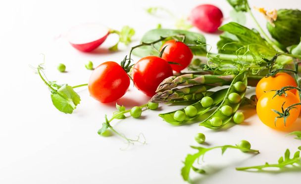 Fresh green  peas pods, radish, green asparagus, tomatoes  - Fotó, kép