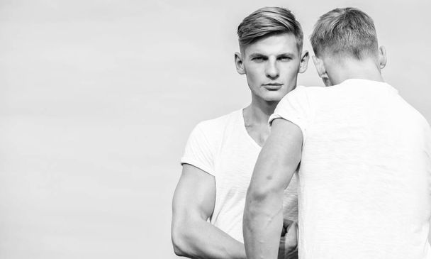 Benefits of having twin brother. Benefits and drawbacks of having identical twin brother. Friendship of brothers. Men twins brothers muscular guys in white shirts sky background. Brotherhood concept - Photo, image