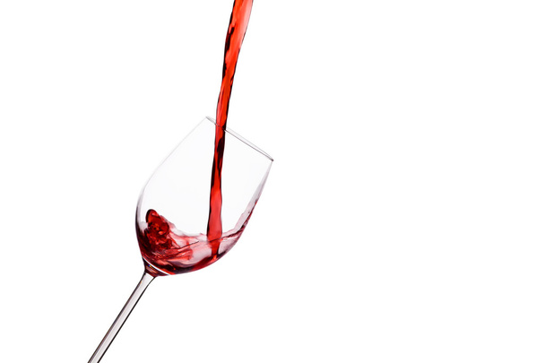 Red wine being poured into a wine glass - Zdjęcie, obraz