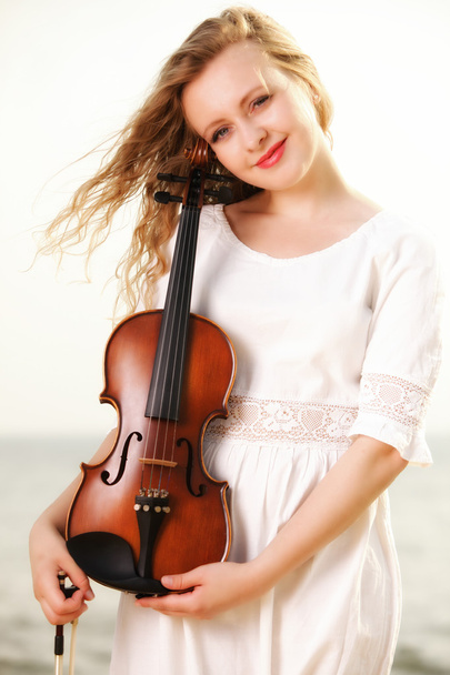 The blonde girl with a violin outdoor - Fotoğraf, Görsel