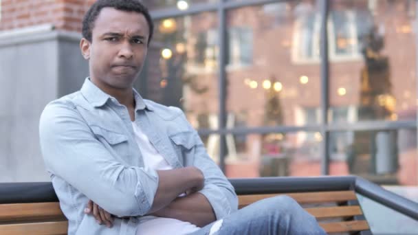 Nem, elutasította fiatal afrikai ember ül a padon - Felvétel, videó