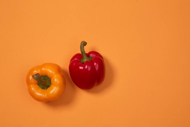 Colorful fruit pattern or background. Two peppers placed on colorful background - Fotoğraf, Görsel